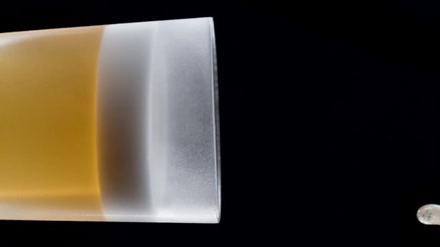 Camera follows pouring beer into glass. Shot with high speed camera, phantom flex 4K. Slow Motion. 