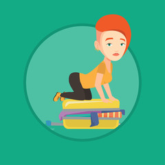 Young woman trying to close suitcase.