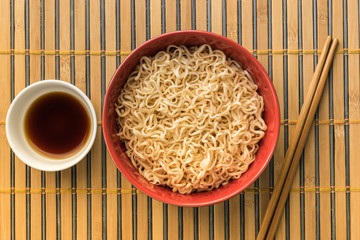 noodles with shoyu or sauce on bamboo or wood backgroound