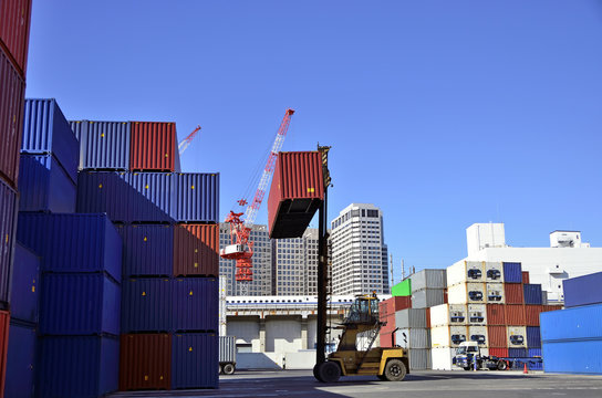 Toplifter handling cargo container loading to container trailer in import export logistic zone
