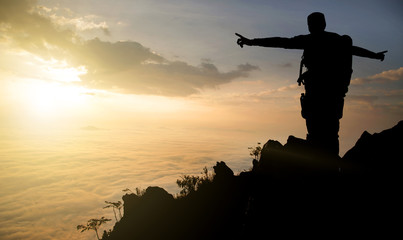 Fototapeta na wymiar silhouette adventurer team on the mountain and sunrise. concept business success