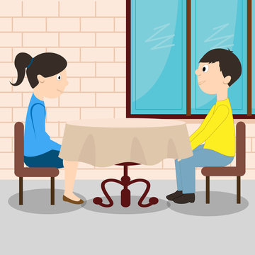 Young romantic couple sitting at the table