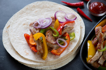 Closeup of tortilla bread with mexican pork fajitas, studio shot