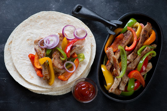 Fajitas with colorful bell peppers and pork meat, top view, studio shot