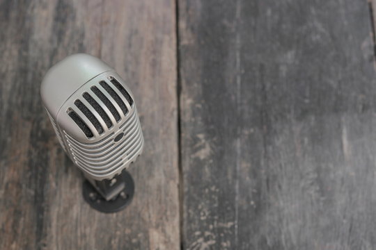 Retro microphone. Vintage style on the wooden floor background  :Select focus with shallow depth of field.