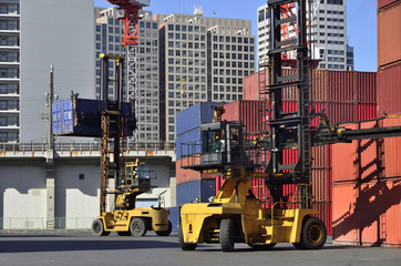 Toplifter handling cargo container loading to container trailer in import export logistic zone
