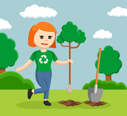 woman environmental activist planting tree