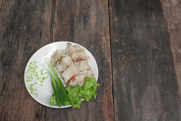 spring rolls with Onion and fresh vegetable on a wooden table