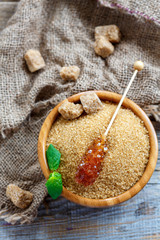 Stick with crystal brown sugar in a wooden bowl.