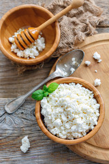 Fresh cottage cheese in wooden bowl.