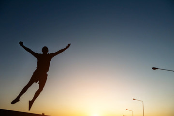 Fototapeta na wymiar silhouette man Jump with happy