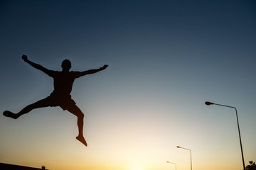 Fototapeta na wymiar silhouette man Jump with happy