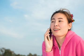 Women talk to friends via mobile phone.