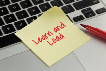 Learn and Lead sticky note pasted on the keyboard