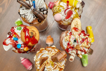 Obraz premium Marshmallow milk shake cocktails with whipped cream, cookies, waffles, treats