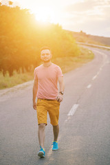 Young man smiling and enjoying sunny summer day