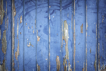 peeling blue paint on wooden door or fence