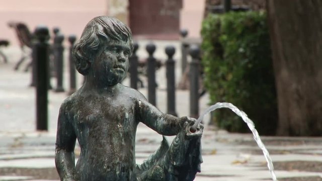 Small fountain of a boy in Jardines de la Alameda Marqu&eacute;s de Comillas in Cadiz Spain