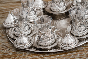 Traditional Silver Coffee Cup Set in a Tray on Wooden Background
