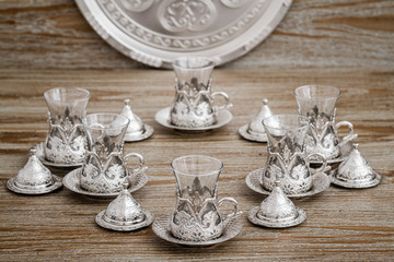Traditional Silver Coffee Cup Set in a Tray on Wooden Background