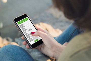 woman registering on a web with her mobile