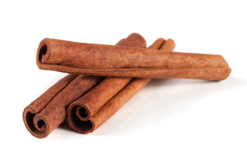 three cinnamon sticks isolated on white background