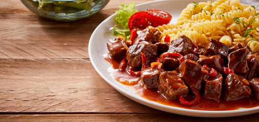 Plain spiral pasta platter served with spicy beef