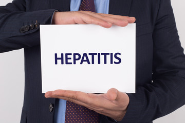 Man showing paper with HEPATITIS text