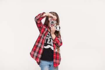 Beautiful child girl holding a instant camera