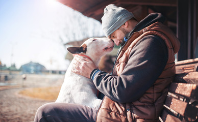 Moments of love between dog and his owner. Pets and animals concept - obrazy, fototapety, plakaty