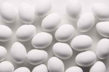 White eggs make pattern on white background