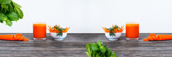 Peeled and cut carrots with fresh squeezed juice on wooden table - concept of healthy eating and drinks.