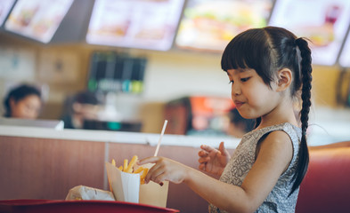 asian child eat in the food court