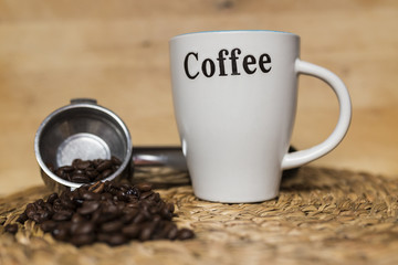 cup of coffee and coffee beans on wood brackground