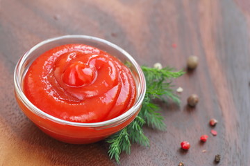 Tomato sauce ketchup with seasonings in a glass bowl