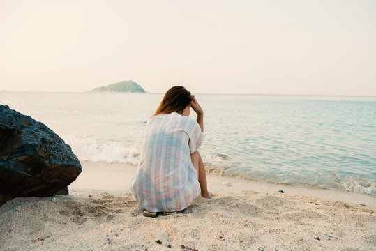 young woman on the beach and be sad concept