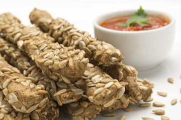 Breadsticks with sunflower seeds, and red sauce