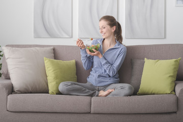 Young woman having lunch at home