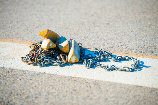 Close up aircraft chocks and chains on the landing field.