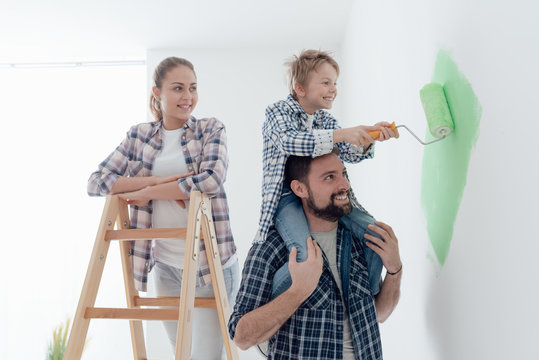 Family painting walls together