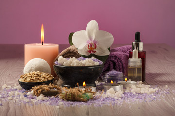 Composition of spa treatment on the light wooden table and pink background