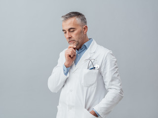 Doctor thinking with hand on chin
