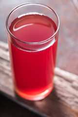 Drink bright red color in a transparent glass