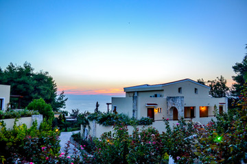 Fototapeta na wymiar Dawn at the sea. luxury Greek hotel Aegean Melathron, Greece - September, 2013.