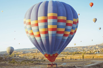 Colorful hot air balloon flying over the valley at Cappadocia, Turkey. Volcanic mountains in Goreme national park