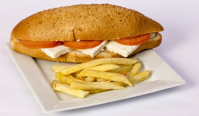 Cheeseburger and fries on restaurant table