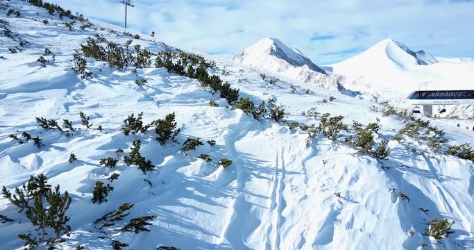 Aerial flight over snowy mountain at winter