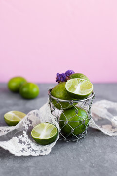 Green limes from Thailand on a pink background