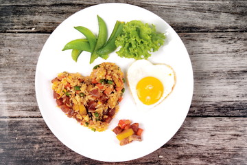 Chinese sausage fried rice and sunny egg in heart shapes.
