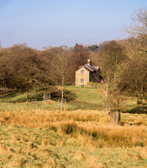 Disley, Stockport, Cheshire, UK. February 14th 2017. Traditional cottage on Lyme Park surrounded by woodland at Lyme Park, Disley, Stockport, Cheshire, UK